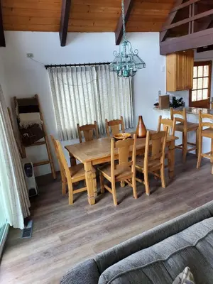 a dining room with a wooden table and chairs at Serenity View, Peaceful & Cheerful 3BD Cabin in Groveland