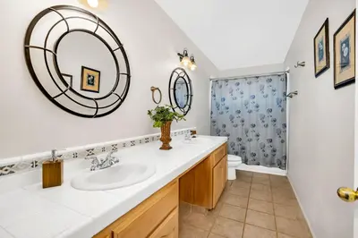 a bathroom with a sink and a mirror at Awesome Views Game Room Hot Tub and More in Oakhurst