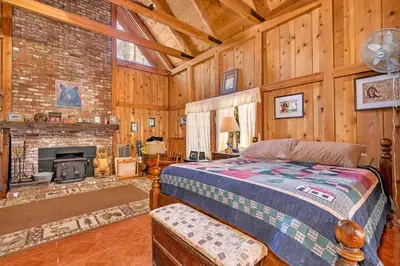 a bedroom with a bed and a fireplace at Rustic Knotty Pine - Old Cabin Vibes in Shaver Lake