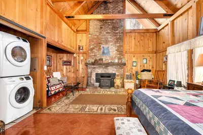 a bedroom with a fireplace and a bed in a room at Rustic Knotty Pine - Old Cabin Vibes in Shaver Lake