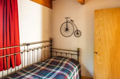 a bedroom with a bike hanging on the wall at Red House - Minutes to Shaver Lake in Shaver Lake