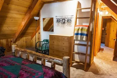 a bedroom with a bunk bed and a ladder at Red House - Minutes to Shaver Lake in Shaver Lake