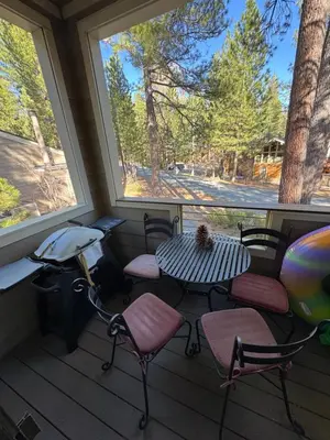 a screened in porch with a table and chairs and a window at Spacious Condo walking distance to Hyatt and Beaches in Incline Village