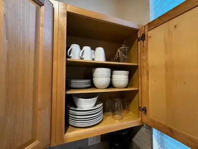 a cupboard with plates and cups and dishes in it at Spacious Condo walking distance to Hyatt and Beaches in Incline Village