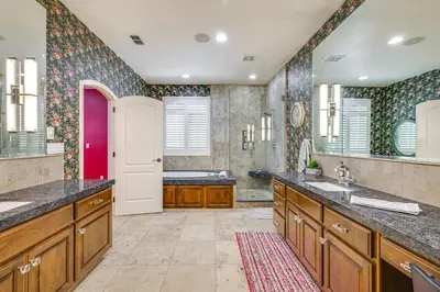 a bathroom with two sinks and a large mirror at 5 Mi to Dtwn Modesto Family Home with Patio! in Modesto