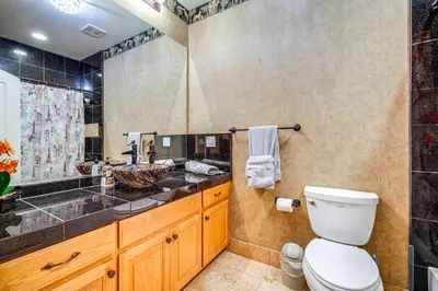 a bathroom with a toilet and a sink and a shower at 5 Mi to Dtwn Modesto Family Home with Patio! in Modesto