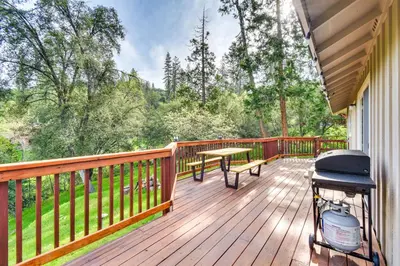 a deck with a grill and a picnic table on it at Sierra Serenity Scenic Mtn Escape with Game Room in Oakhurst