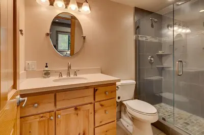 a bathroom with a toilet and a sink and a shower at Hyphen 4-bedrooms rental, private beach, filtered view in Tahoe City
