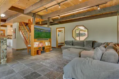 a living room with two couches and a staircase at Hyphen 4-bedrooms rental, private beach, filtered view in Tahoe City