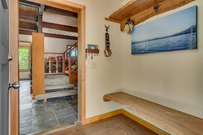 a hallway with a door leading into a room with a staircase at Hyphen 4-bedrooms rental, private beach, filtered view in Tahoe City