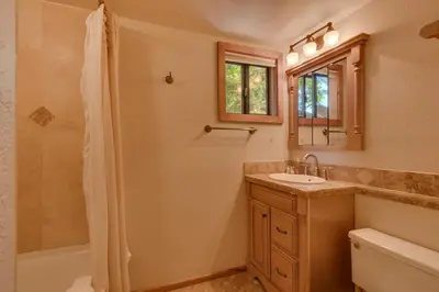 a bathroom with a shower and a sink and a mirror at Hyphen 5-bedrooms rental, private beach, filtered view in Tahoe City