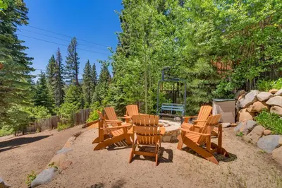 a group of chairs and a table in the sand at Hyphen 5-bedrooms rental, private beach, filtered view in Tahoe City
