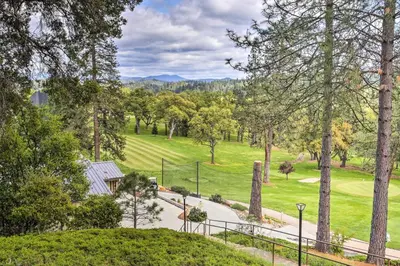an aerial view of a golf course with trees at Yosemite Home Base Community Perks and Lake Access! in Groveland