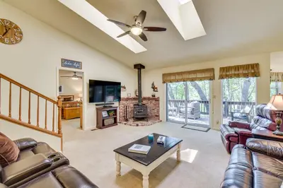 a living room with a couch and a table at Yosemite Home Base Community Perks and Lake Access! in Groveland