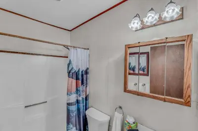 a bathroom with a toilet and a window at Spacious Truckee Retreat with Fireplace & Deck in Truckee