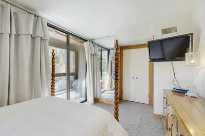 a bedroom with a bed and a flat screen tv at Silver Strike Summit in Truckee