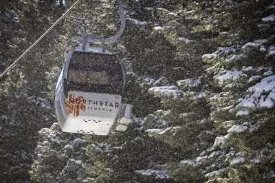 a ski lift in the snow on a mountain at Silver Strike Summit in Truckee