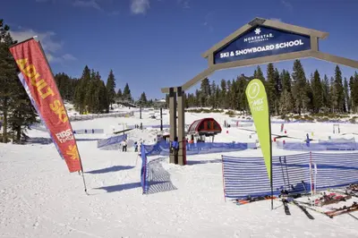 a ski resort with signs in the snow at Silver Strike Summit in Truckee
