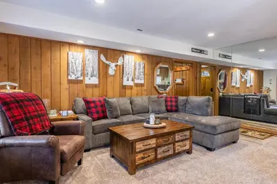 a living room with a couch and a table at Ground Level, Sunshine Village #171- 2 bed/2 bath, Sleeps 6. Steps from Free Town Shuttle in Mammoth Lakes