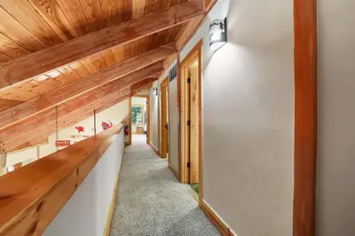 a hallway of a house with wooden ceilings at WSH1030 - Camp Westwater home in Tahoma