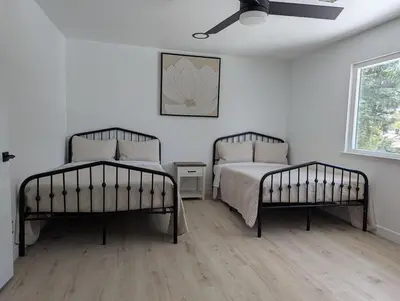 a bedroom with two beds and a window at Welcome to Lilith's House! in Clovis