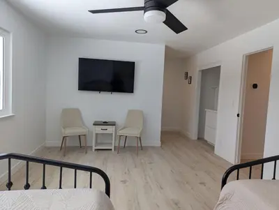a bedroom with a bed and a tv on a wall at Welcome to Lilith's House! in Clovis