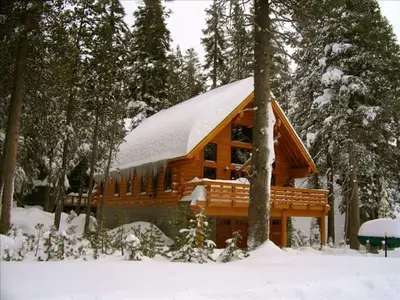 a cabin in the woods with snow on the roof at Updated Winter Getaway Great for Skiing in Soda Springs, California in Soda Springs