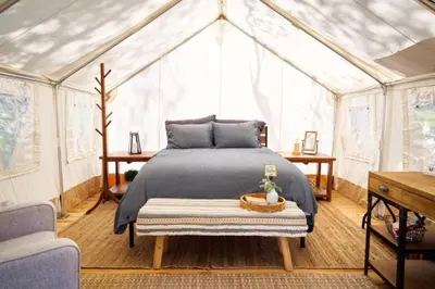 a bedroom with a bed in a tent at Secluded Safari Tent Situated in Rural Western El Dorado County Overlooking Majestic Folsom Lake, Northern California in Pilot Hill