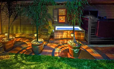 a backyard with three potted plants and a pool at Quiet Cottage Rental for Two in Horse Country near Yosemite National Park Gateway, California in Catheys Valley