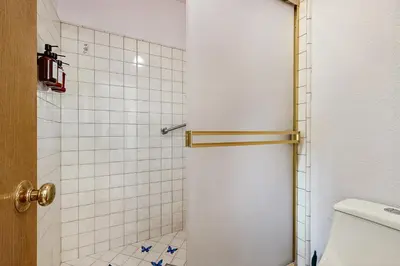 a bathroom with a shower with a toilet and tiles at Harmony Haven in Groveland
