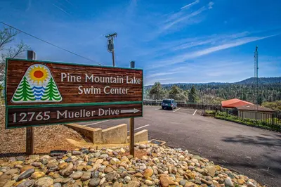 a sign for a pine mountain lake swim center on a road at Harmony Haven in Groveland
