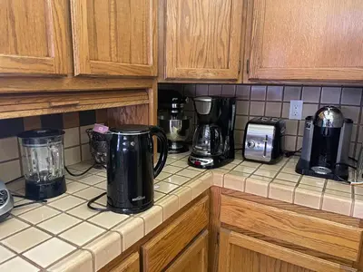 a kitchen counter with various appliances on it at Discovery Bay Home on fast water - 2,400Sq ft in Discovery Bay
