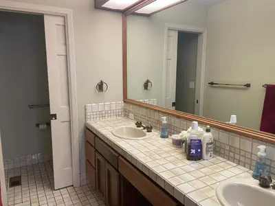 a bathroom with two sinks and a large mirror at Discovery Bay Home on fast water - 2,400Sq ft in Discovery Bay