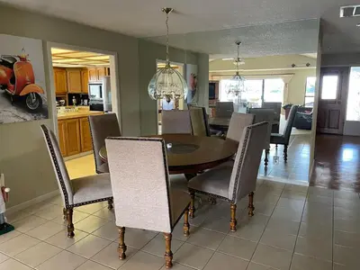a dining room and kitchen with a table and chairs at Discovery Bay Home on fast water - 2,400Sq ft in Discovery Bay