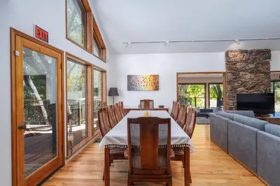 a dining room with a table and a couch at Spacious Mountain View Home - Pool, Spa & Game Rm in Oakhurst