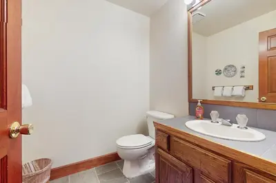 a bathroom with a sink and a toilet and a mirror at Peace and Pines at Upper Ward Creek in Tahoe City