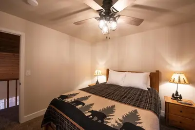 a bedroom with a bed and a ceiling fan at Charming and Relaxing Getaway with Great Views in Shaver Lake