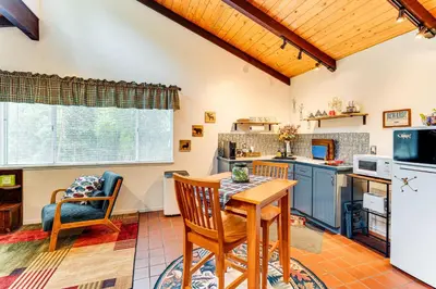 a kitchen with a table and chairs and a refrigerator at Hidden Valley Retreat - Outdoorsy West Point Gem in West Point