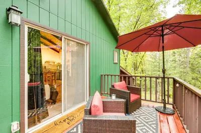 a porch with a chair and an umbrella at Hidden Valley Retreat - Outdoorsy West Point Gem in West Point