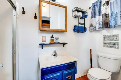a bathroom with a toilet and a sink and a mirror at Hidden Valley Retreat - Outdoorsy West Point Gem in West Point