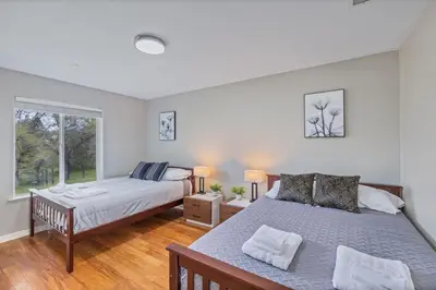 a bedroom with two beds and a window at Green Meadows at Sky Ranch, 13 miles from Yosemite in Oakhurst