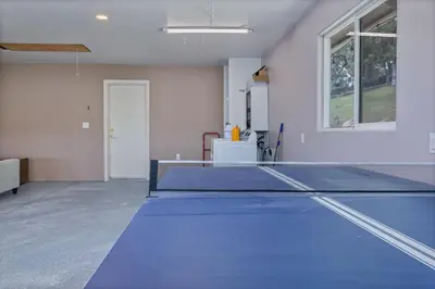 an empty room with a ping pong table in it at Green Meadows at Sky Ranch, 13 miles from Yosemite in Oakhurst