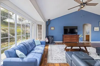 a blue living room with a blue couch and a table at Sunset Lookout Mountain villa, Meadows, Gazebo in Coarsegold