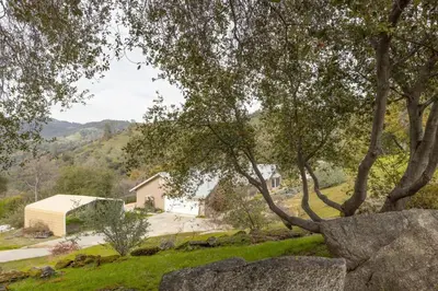 a house on a hill with trees and a driveway at Sunset Lookout Mountain villa, Meadows, Gazebo in Coarsegold