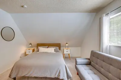 a bedroom with a bed and a couch at Backyard Forest Retreat in South Lake Tahoe