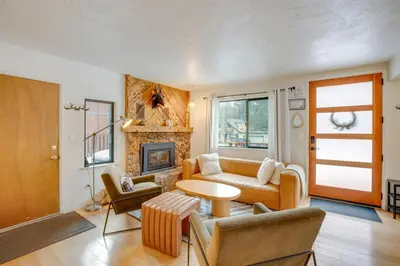 a living room with a couch and a fireplace at Backyard Forest Retreat in South Lake Tahoe