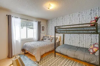 a bedroom with a bunk bed next to a window at Backyard Forest Retreat in South Lake Tahoe