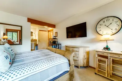 a bedroom with a bed and a clock on the wall at Hike, Sled and Ski! Cozy Tahoe City Condo with Hot Tub in Tahoe City