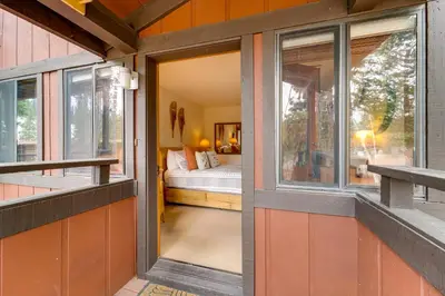 an open door to a bedroom with a bed at Hike, Sled and Ski! Cozy Tahoe City Condo with Hot Tub in Tahoe City