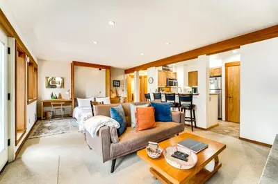 a living room with a couch and a table at Hike, Sled and Ski! Cozy Tahoe City Condo with Hot Tub in Tahoe City